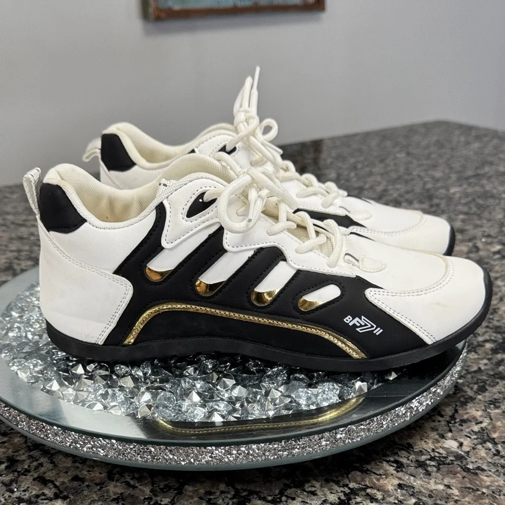 White and Black womens fashion Sneakers with gold accents EUC 10